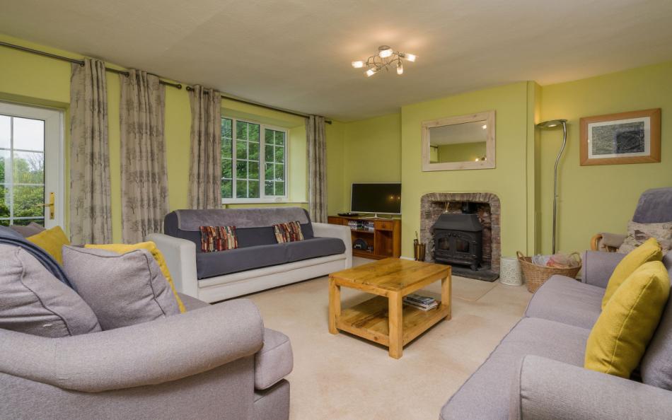 The living room with log burner at Coombe Park