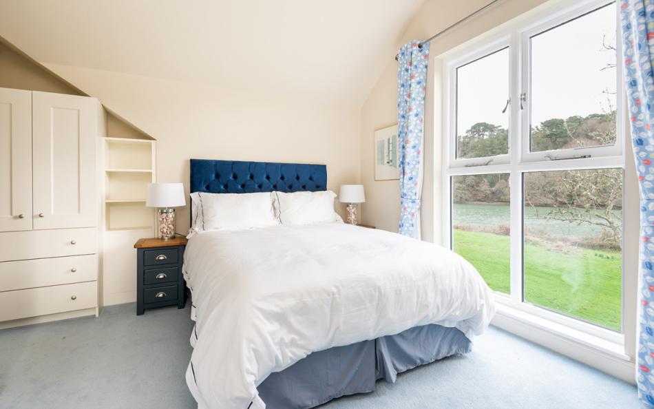 The master bedroom at The Boathouse looks up the estuary to Waterhead