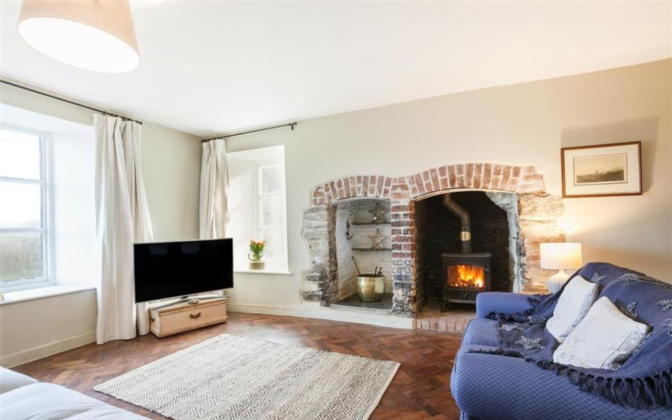 Formal lounge with lovely character features and log burner at Higher Sutton