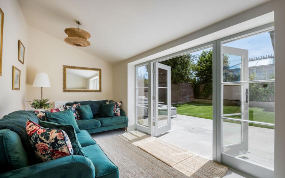 Lovely sitting room with doors that open out to the garden at Carrington Farmhouse