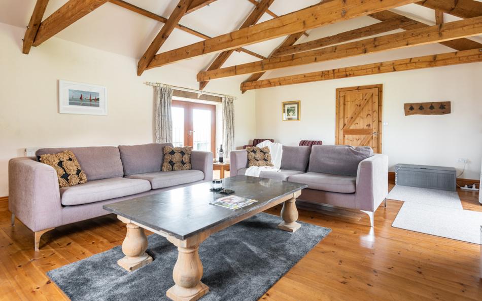 Large, bright lounge with access to front garden at Landgreek Barn