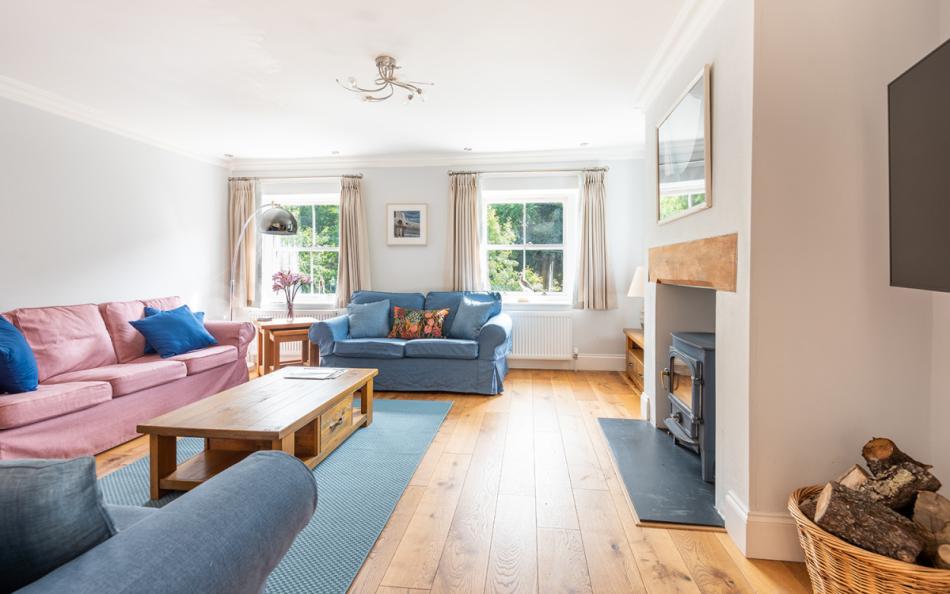 The spacious bring lounge with log burner at Burnt House