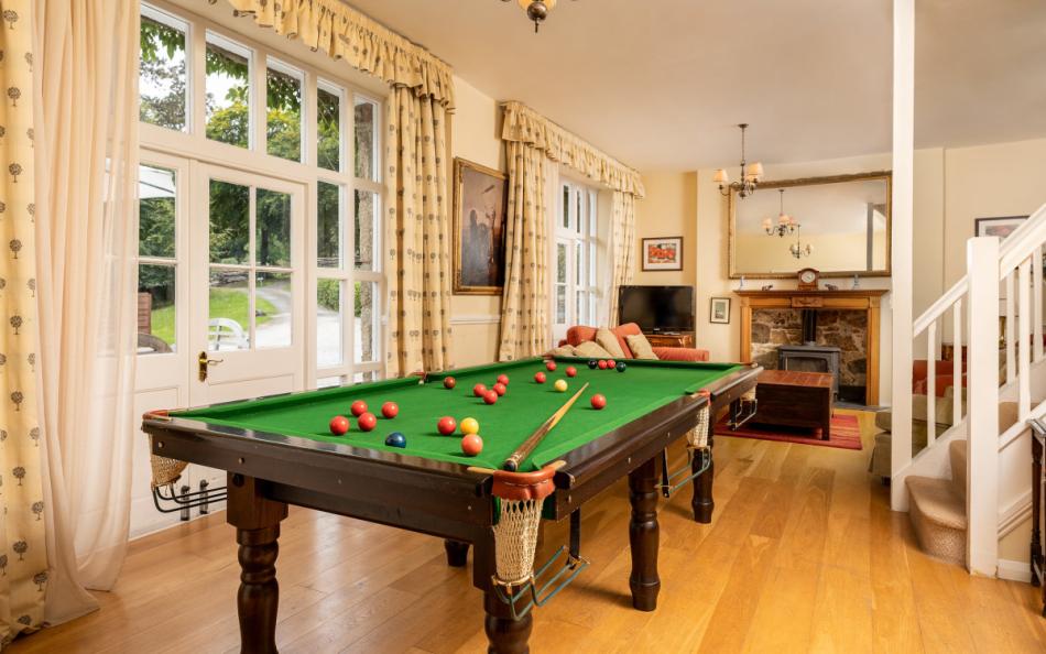 The living room complete with a billiards table at Holne Chase Carriage House