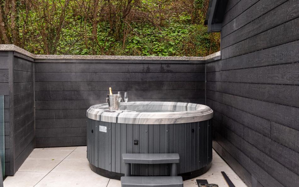 Relax in the hot tub and breathe in the sea views at Howldrevel 