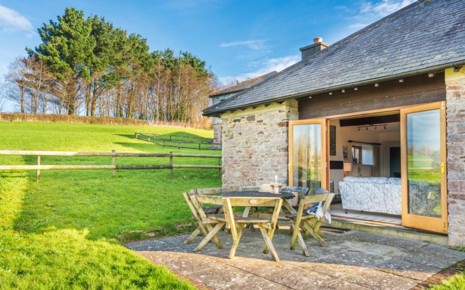 Private patio with bench style table and seating at Blackness Barn