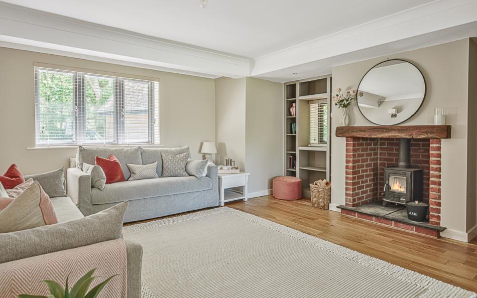 Lovely sitting room with a wood burner at Woodland Cottage