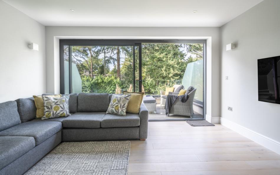 indoor lounge leading to outdoor sofas at Nautiques near Poole