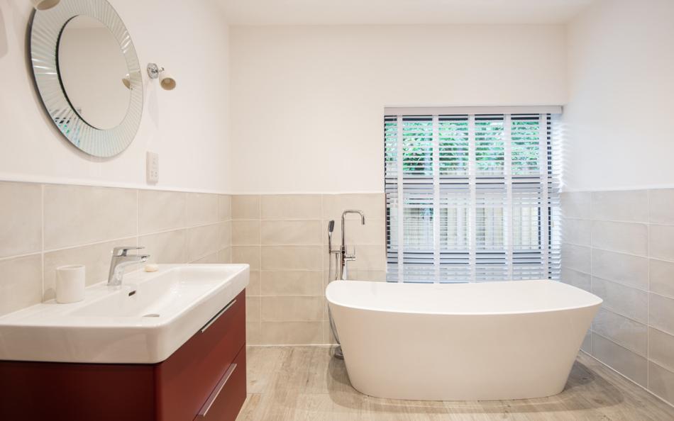 Downstairs family bathroom with freestanding bath at Acacia House 