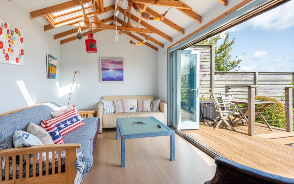Studio sitting room with bi-fold doors at Dunedin Cottage