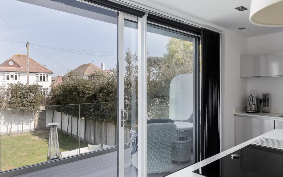 Patio doors from kitchen to balcony overlooking the garden at Leeward