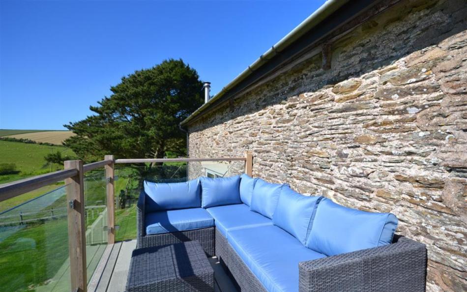 Comfortable seating on the balcony at Court Barton Loft