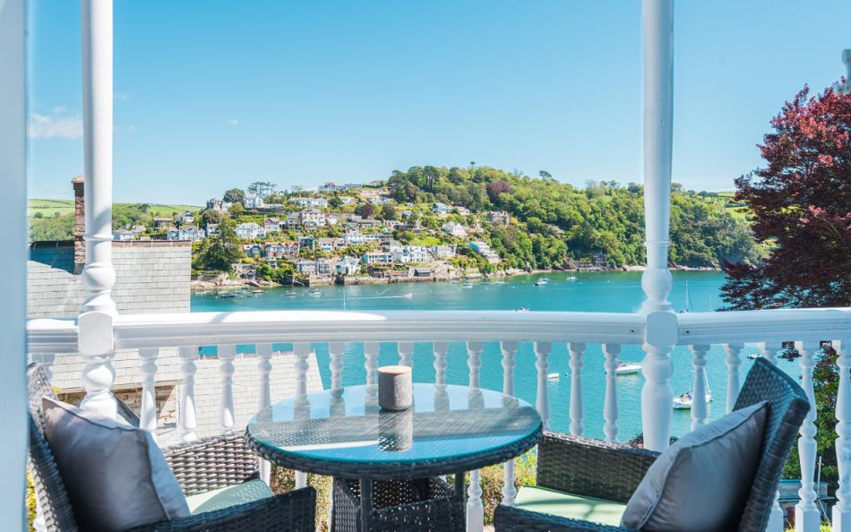 Enjoy morning coffee or evening beverage on the river facing balcony at Halcyon House