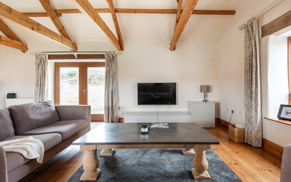sofas by the fire at Landgreek Barn