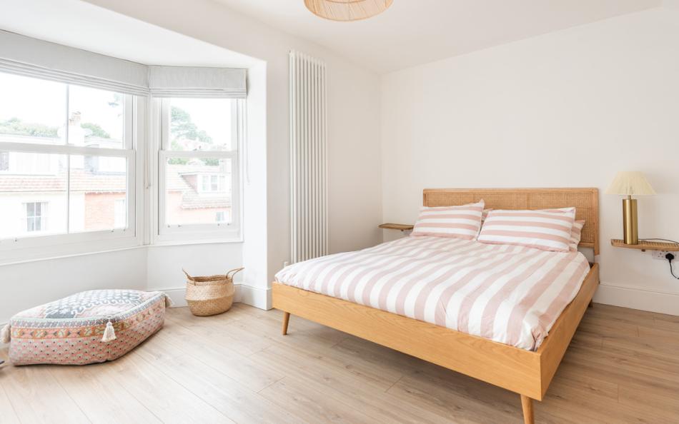 Master bedroom with a King size bed and pretty bay window at Craiglands