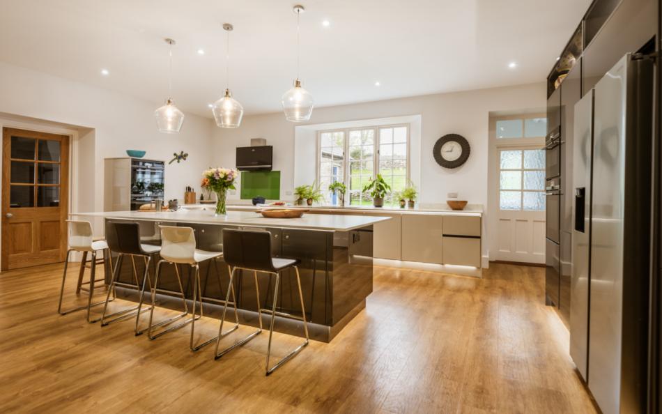 Whole kitchen with view out the back of the house at Bigbury Court Farmhouse