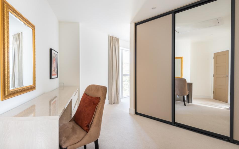The dressing area in the master suite screened by a floating wall from the bedroom area