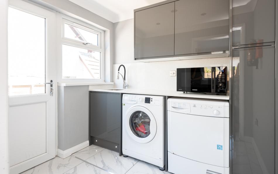 The utility room with washer, dryer and microwave at 1 Crestfields