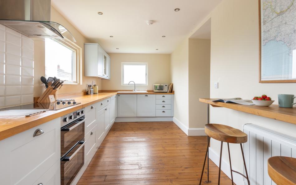spacious kitchen with views over the sea at 1 Ivy Cove