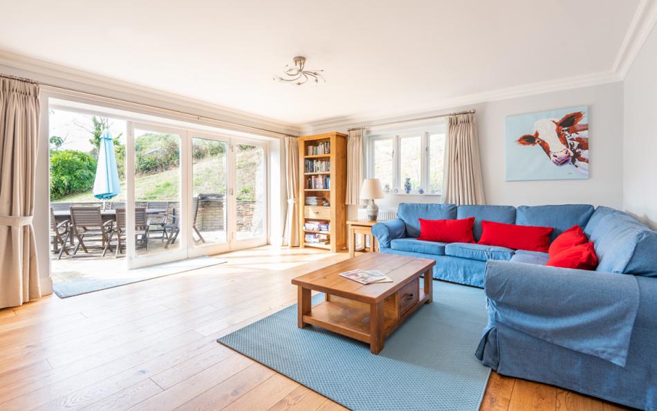 sofas with doors to the garden at Burnt House