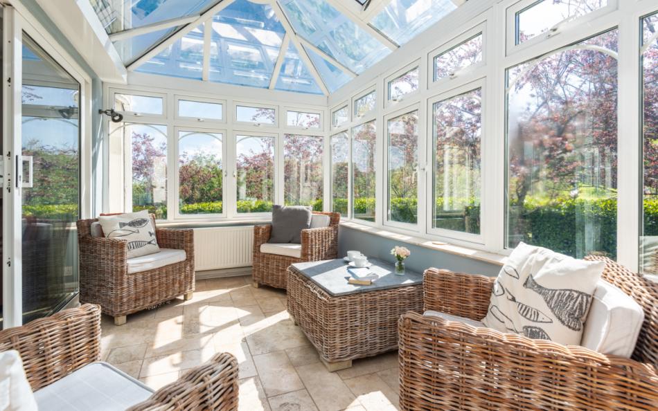 The sun room with views of the garden at Clover Cottage