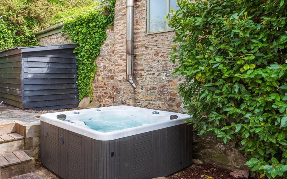 The hot tub, perfect for unwinding at the end of the day at Huccombe Farmhouse 