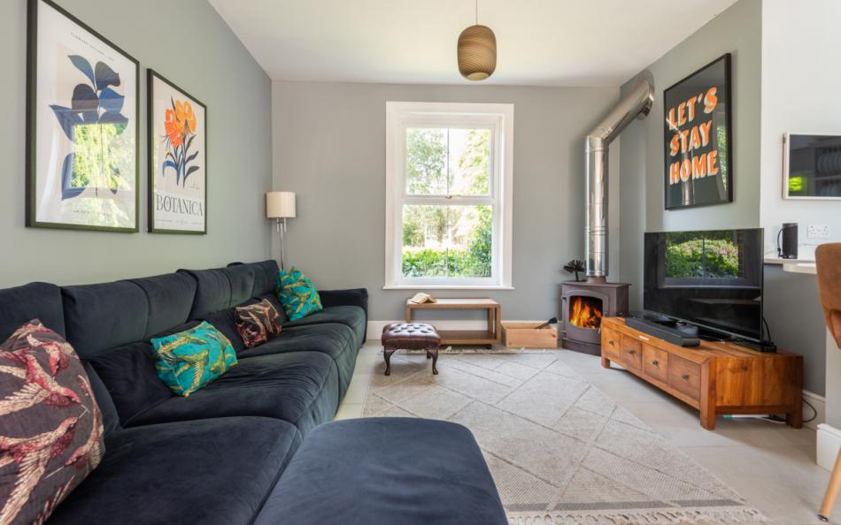 Social seating with log burner at Corner Cottage