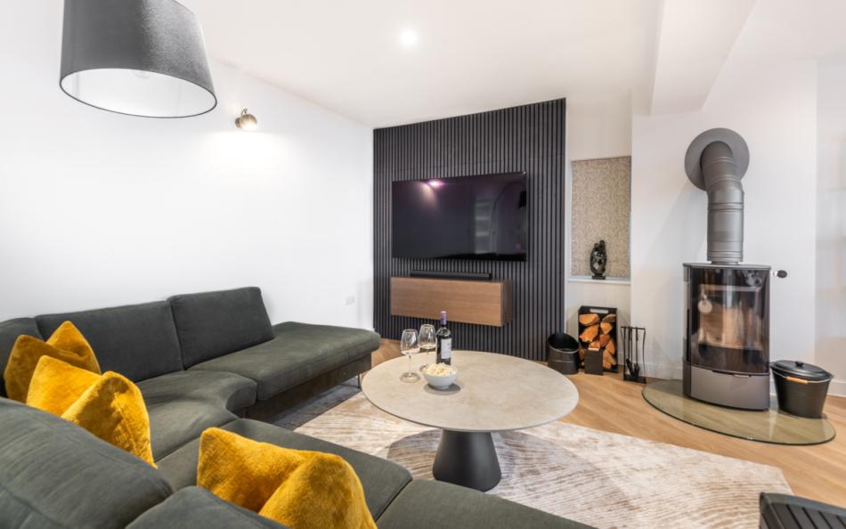 Modern interiors with a cosy log burner for cooler evenings at Agincourt