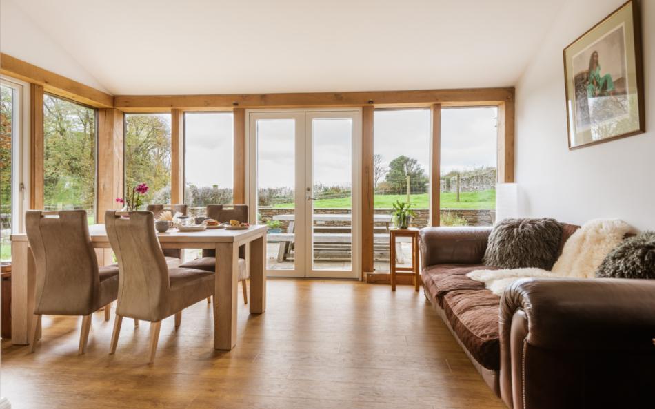 Sofa in sunroom  at Bigbury Court Farmhouse