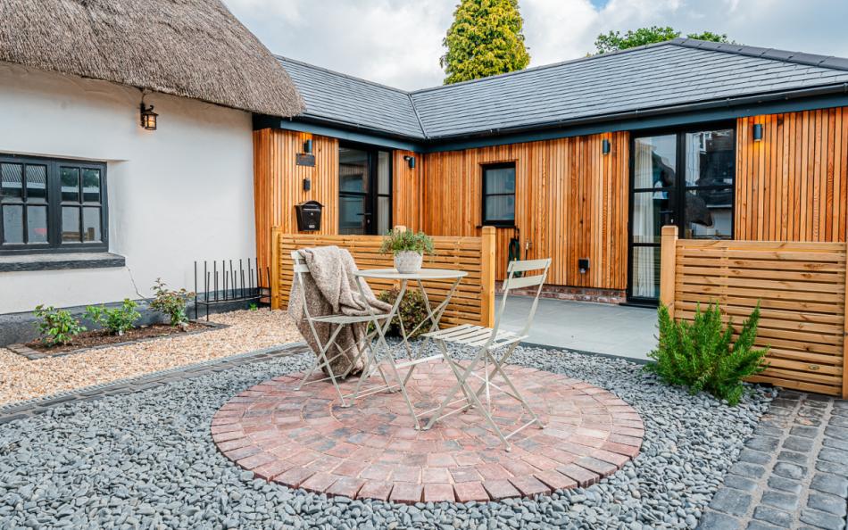outdoor seating in the garden at Fiddlesticks Cottage