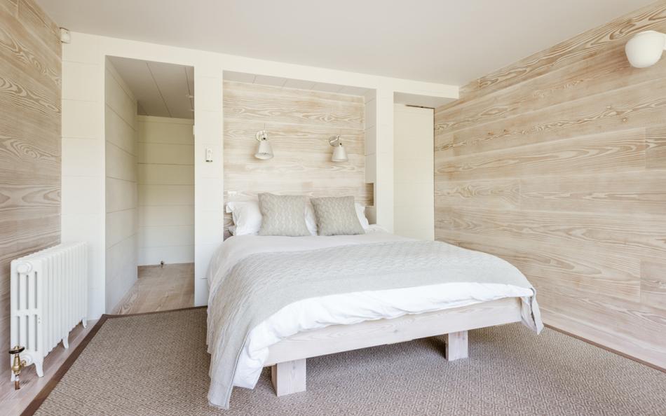 The master bedroom in the modern extension looks over the rear garden at Huccombe Farmhouse 