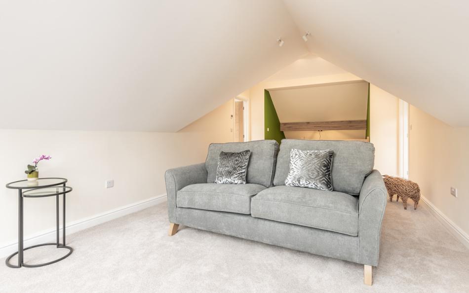 Upstairs snug with 3 seater sofa at Acacia House 