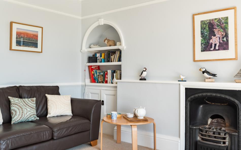 sofa by open fire at The Ridings in Slacombe