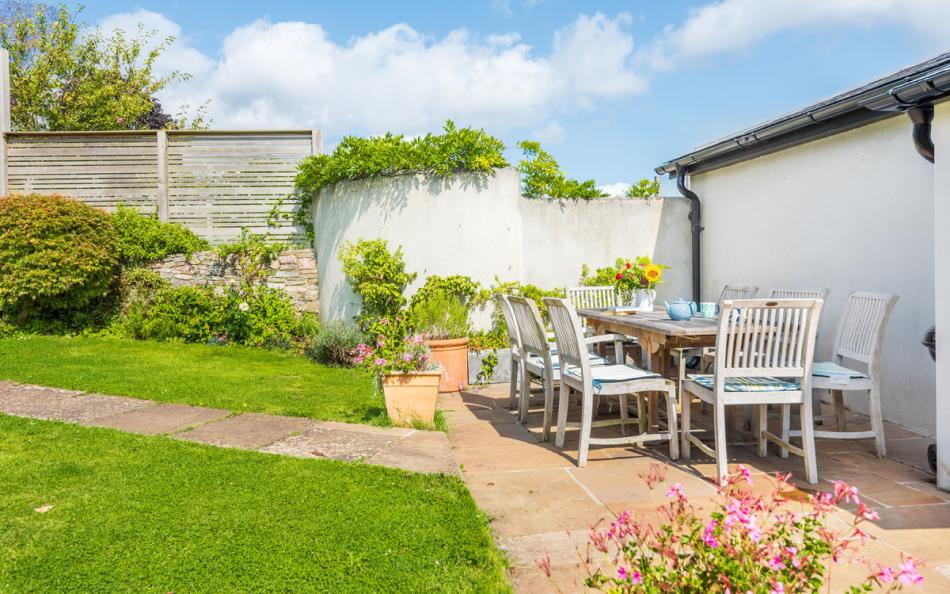 Rear paved patio with table and chairs for 8, perfect for alfresco eating at Dunedin Cottage