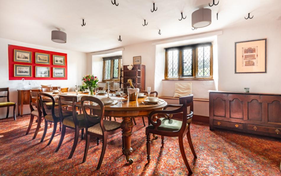 Dining room with seating for 10 & woodburner at Pengenna Manor