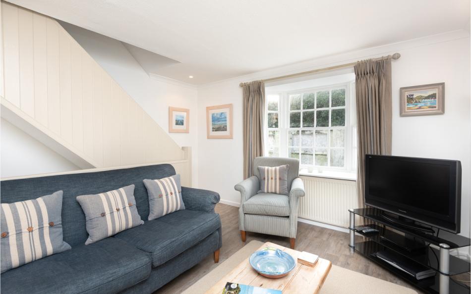 The sitting room with tv at 1 Kings Cottages