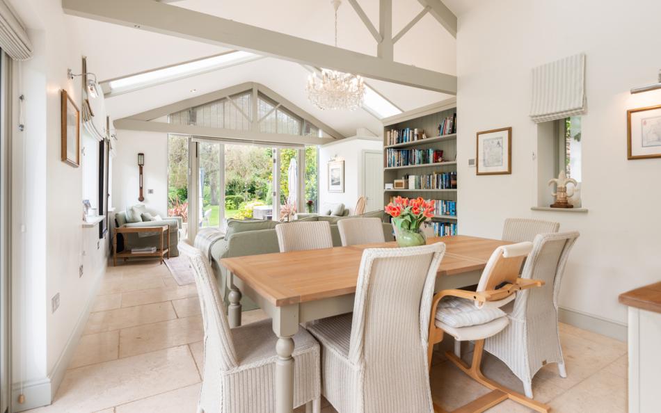 Architecturally designed sunroom with dining area at Bow Bridge House 