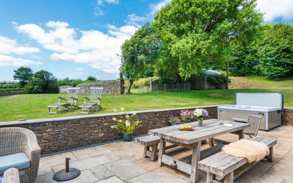 View over patio and gardens at Bigbury Court Farmhouse