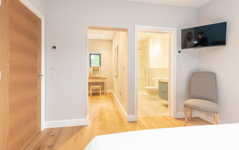 Bedroom 1 with ensuite shower room and dressing area at Acacia House 