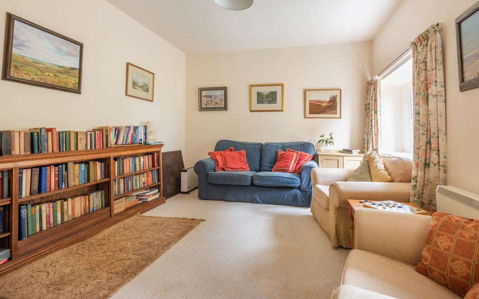 Sitting room with books at Holmbush 