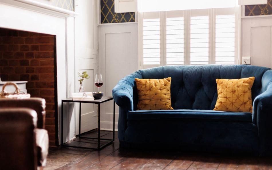 sofas by the fire at Saddlers Cottage