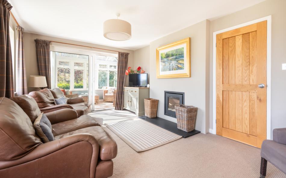 Lounge with log burner at Clover Cottage