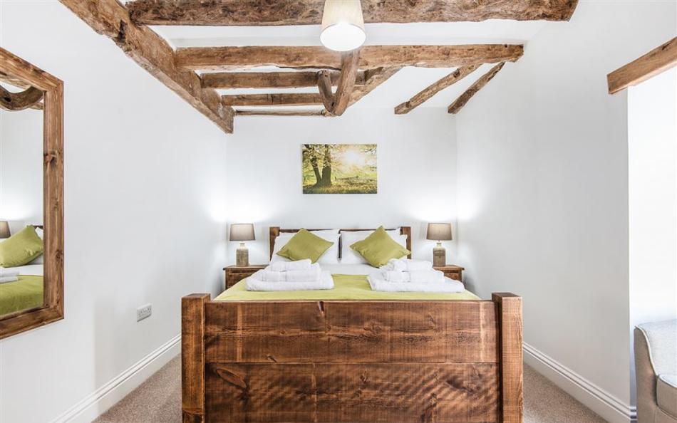 The sumptuous bedroom on the ground floor at Berry's Barn 