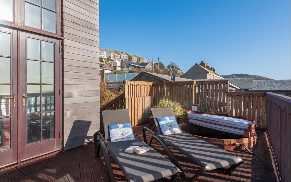 Sunbeds on the terrace next to the hot tub at Bayview
