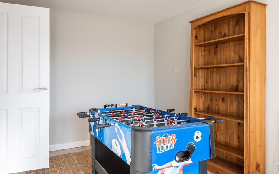 The play room with table football and dart board at Blue Shores