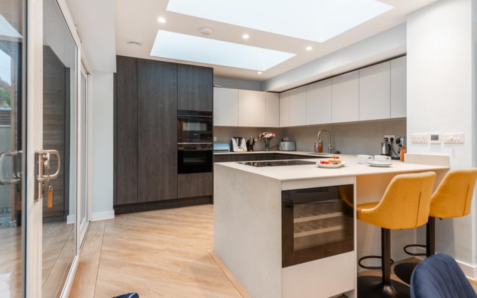 Modern kitchen with breakfast bar and wine fridge at Agincourt