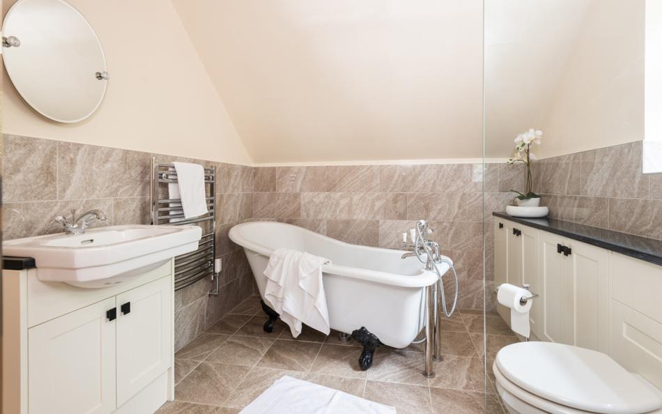 Bathroom with roll top bath at Gorselands Cottage