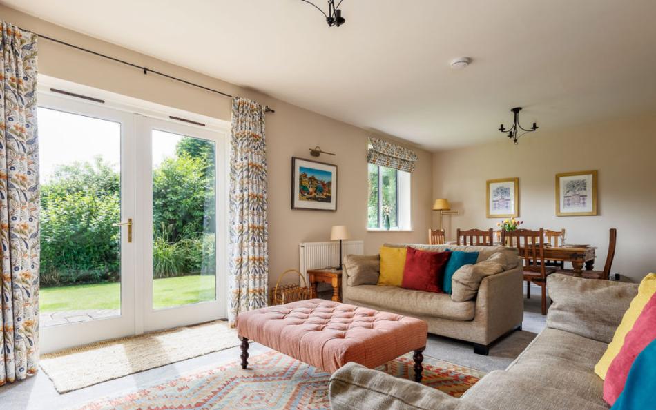 lounge with open doors at Old Farm Cottage