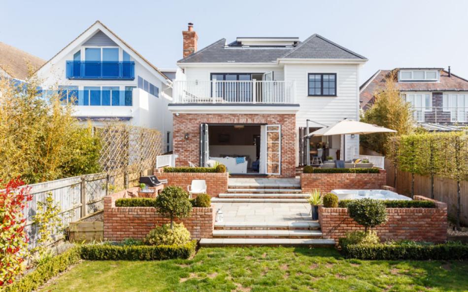 Rear patio and garden with hot tub at Number Twelve in Sandbanks 